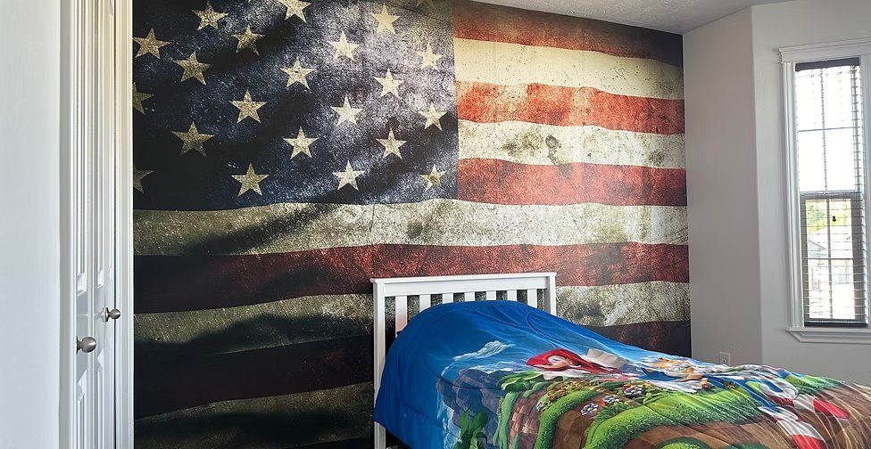 Distressed American flag mural covering a child's bedroom feature wall